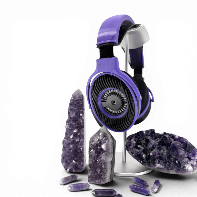 Satyr4 DIY Purple over-ear headphones on a stand, surrounded by amethyst crystals of various sizes