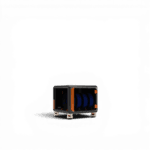 Dark grey storage unit with orange corner fittings on small feet, holding three blue filament spools inside an open-fronted enclosure