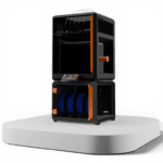 3D printer with black and orange frame, featuring a print chamber on top and a filament storage unit below holding blue spools